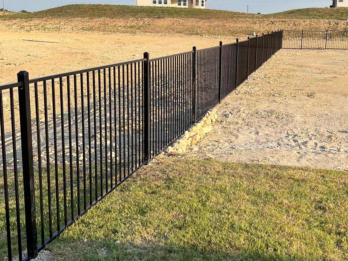 Fence with Durable Black Aluminum Fence Installation on Sloped Terrain – New Construction Area in Fort Worth, T in Fort Worth, TX