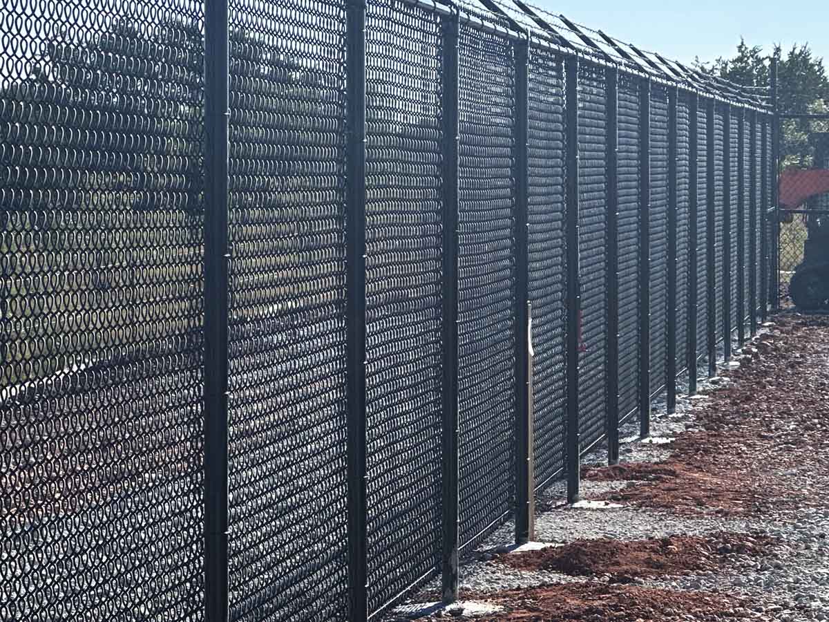 Fence with Heavy-Duty Black Chain Link Fence with Barbed Wire – Industrial Security Barrier Installation in Fort Worth, TX