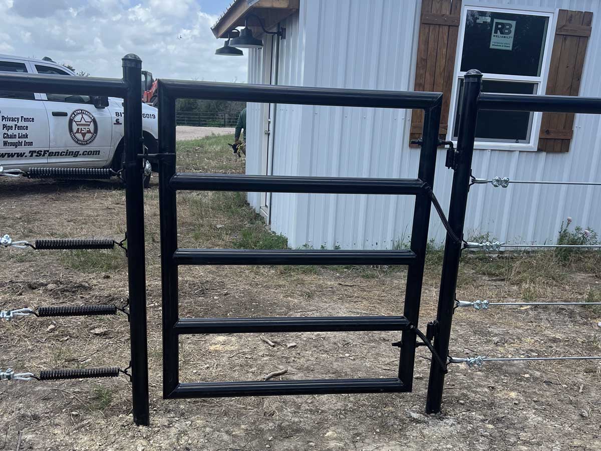 Fence with Black Pipe Fence Gate with Wire Tension Springs – Ranch or Agricultural Entrance Solution in Fort Worth, TX