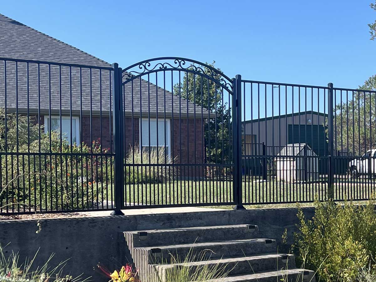 Fence with Ornamental Iron Gate with Arched Top and Scrollwork – Elegant Entry for Residential Property in Fort Worth, TX