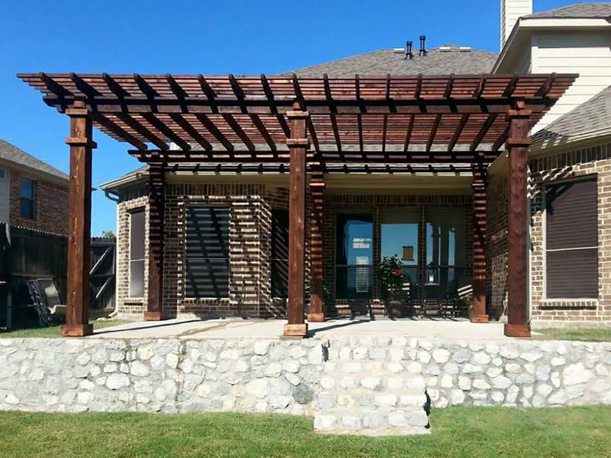 Fence with Wood pergola built on a concrete deck for a residential home in Fort Worth TX in Fort Worth, TX