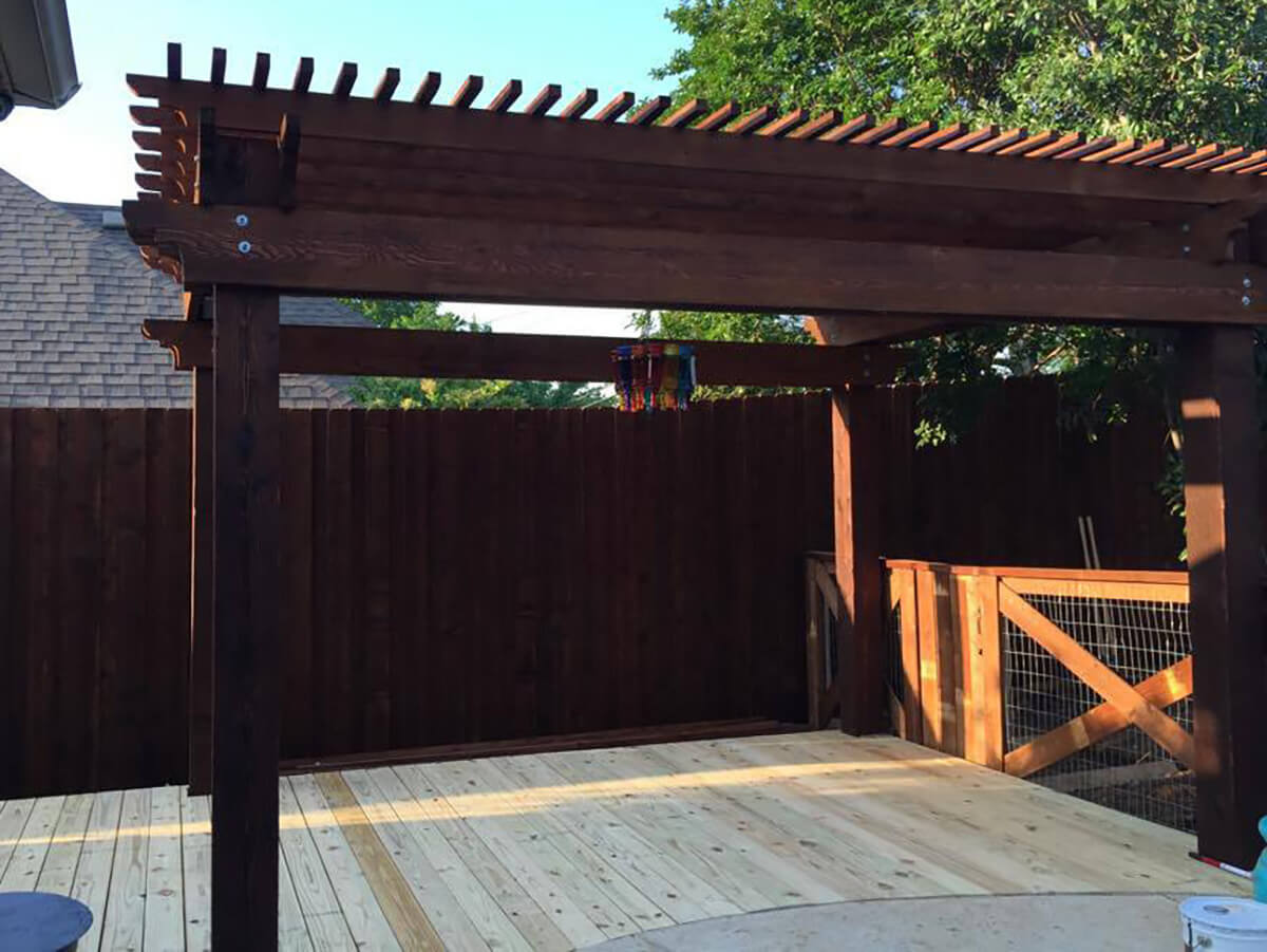 Fence with Wood pergola built on a wood deck for a residential backyard patio in Fort Worth TX in Fort Worth, TX