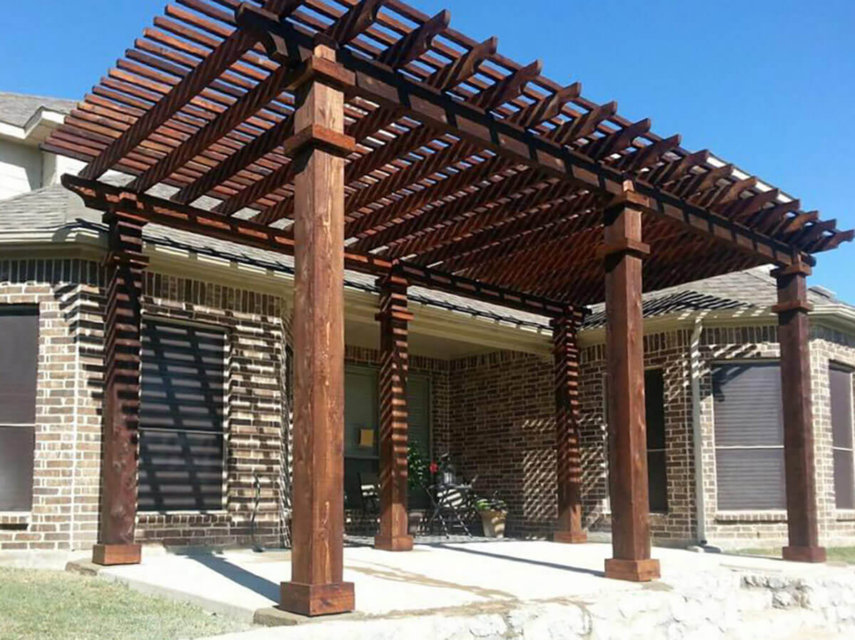 Fence with Wood pergola built in Fort Worth TX on a concrete deck for a residential home patio in Fort Worth, TX
