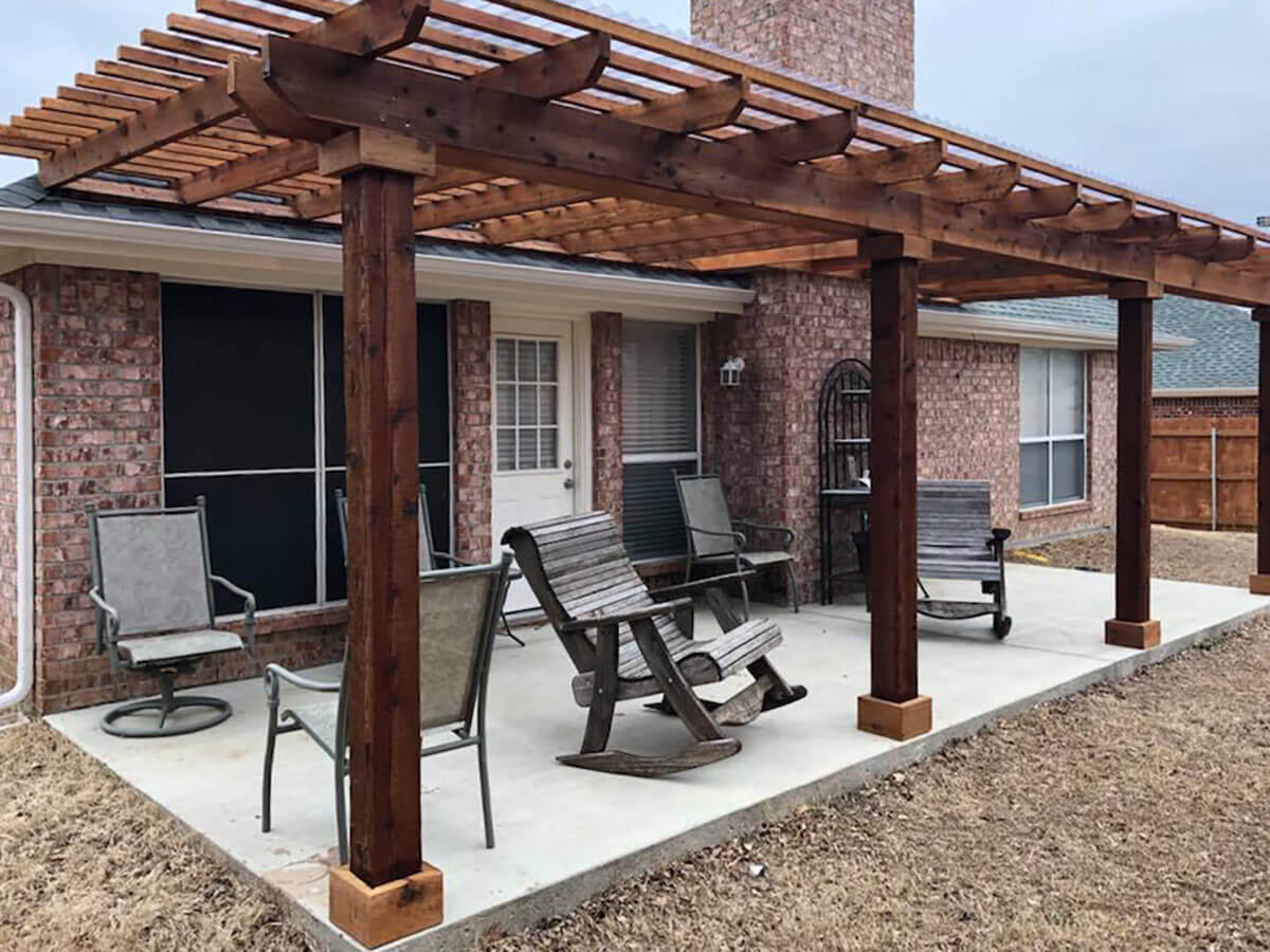 Fence with Wood pergola built on a concrete deck for a residential back patio in Fort Worth TX in Fort Worth, TX