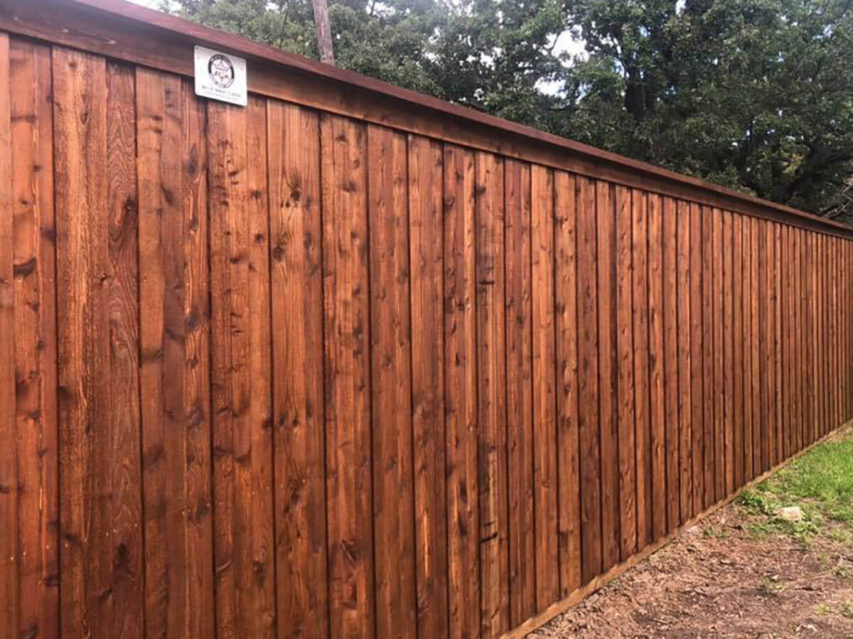 Fence with Stained board on board wood fence with cap and trim installed in Fort Worth TX around a backyard in Fort Worth, TX