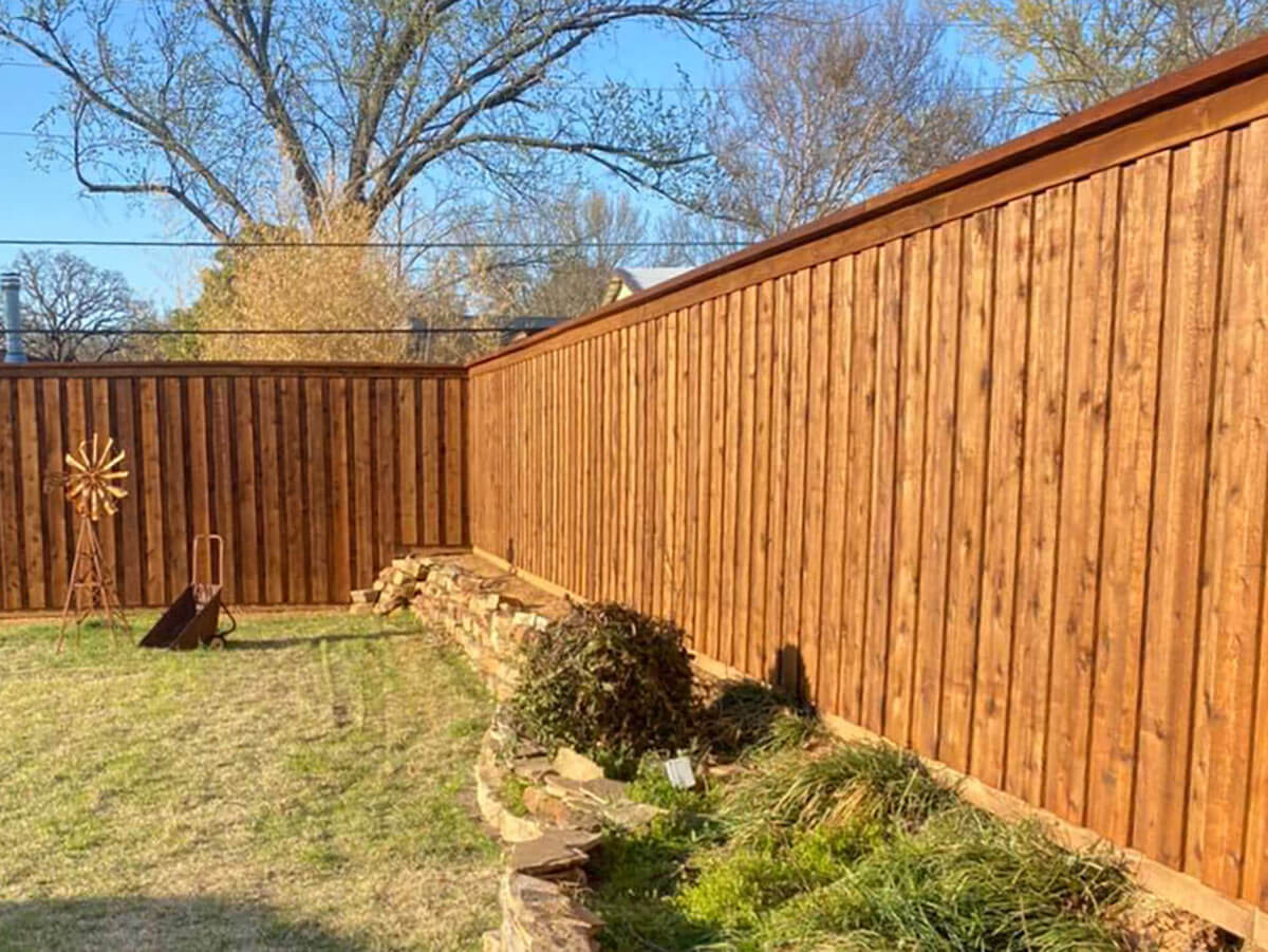 Fence with Fence staining company in Fort Worth TX for a board on board wood fence with cap and trim in Fort Worth, TX
