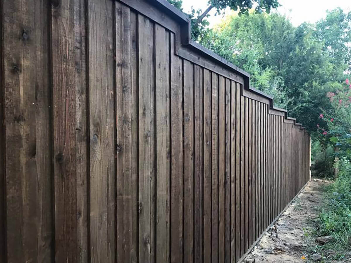 Fence with Board on board stained wood fence with cap and trim at multiple heights installed in Fort Worth TX in Fort Worth, TX