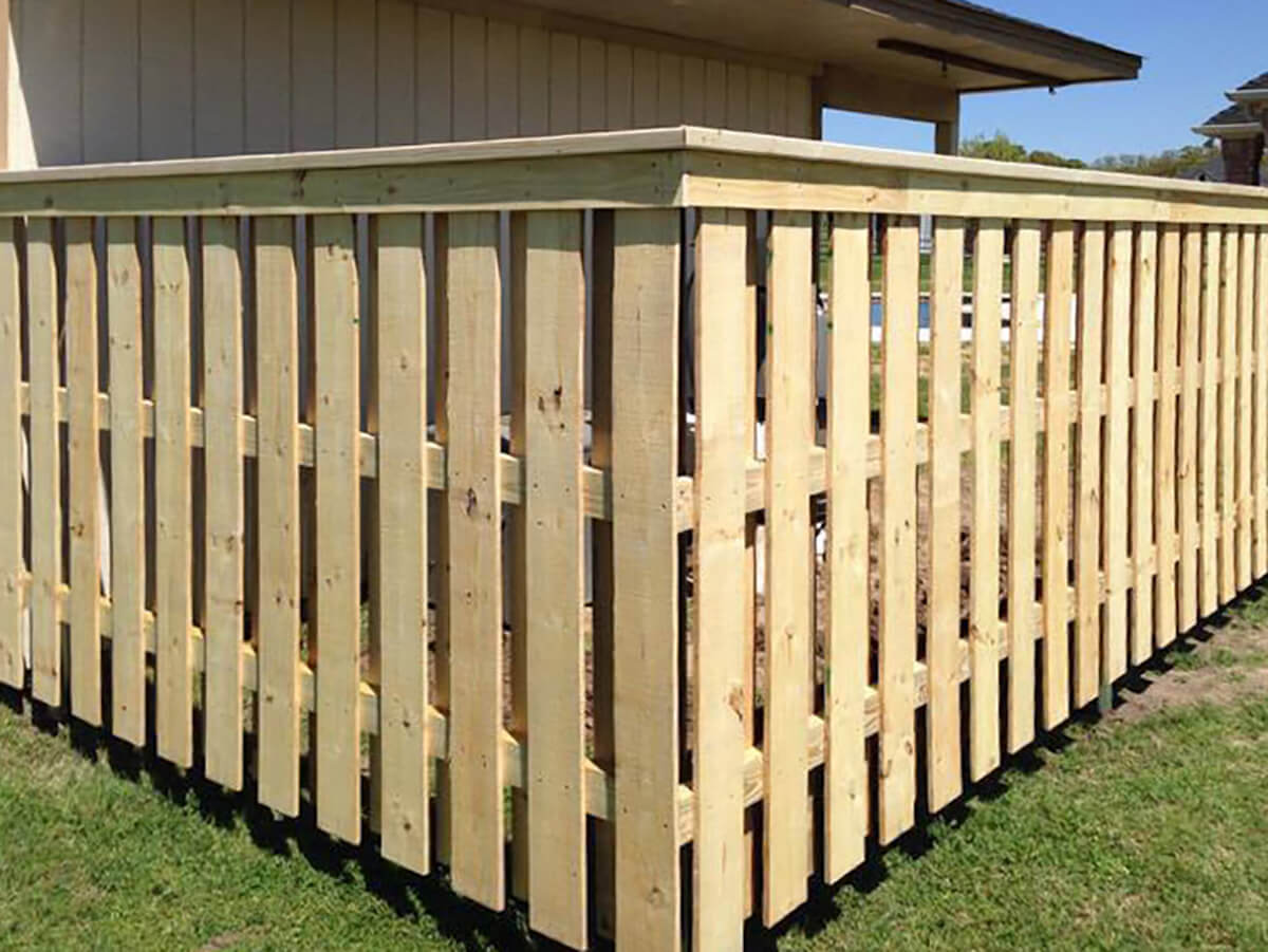 Fence with Wood picket fence with cap and trim installed around a home in Fort Worth TX in Fort Worth, TX