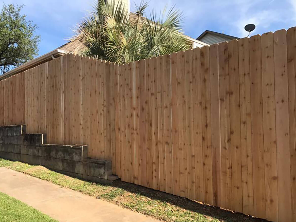 Fence with Dog ear stockade wood fence installed between the home and sidewalk in Fort Worth TX in Fort Worth, TX
