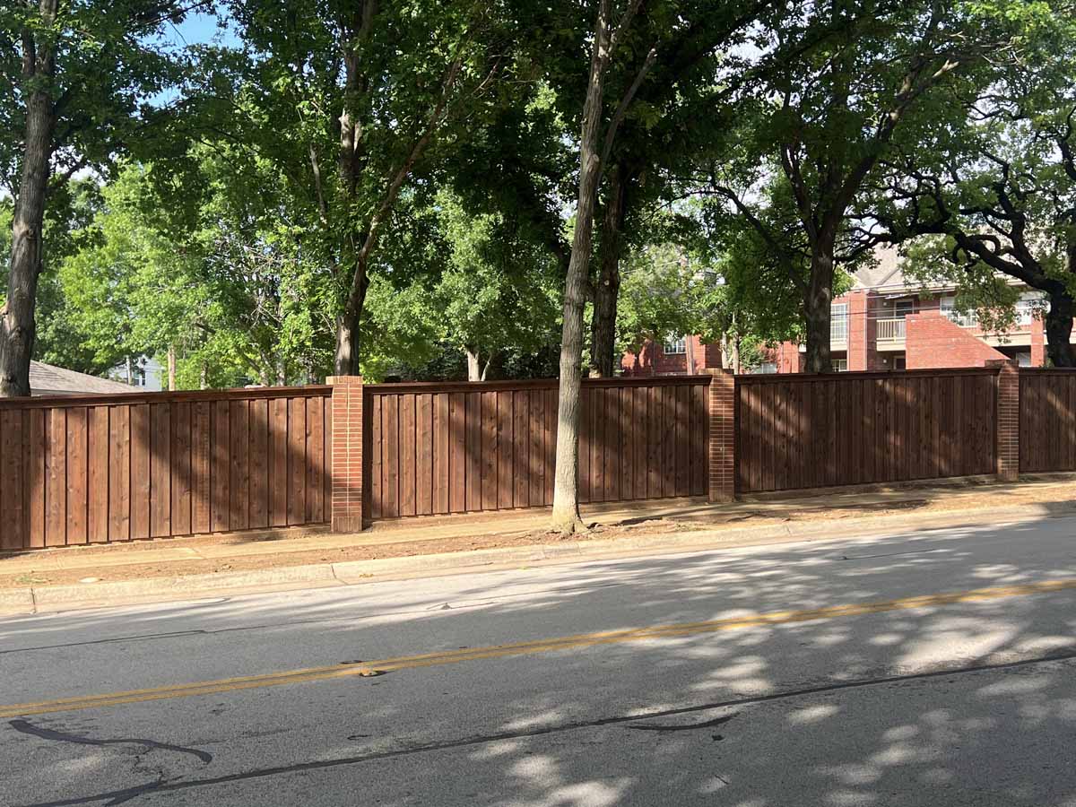 Fence with Stained Wood Privacy Fence with Brick Columns – Decorative Perimeter Fence for Residential Community in Fort Worth, TX